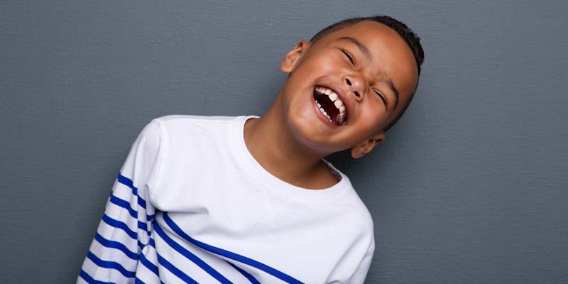 Child laughing with dental sealants